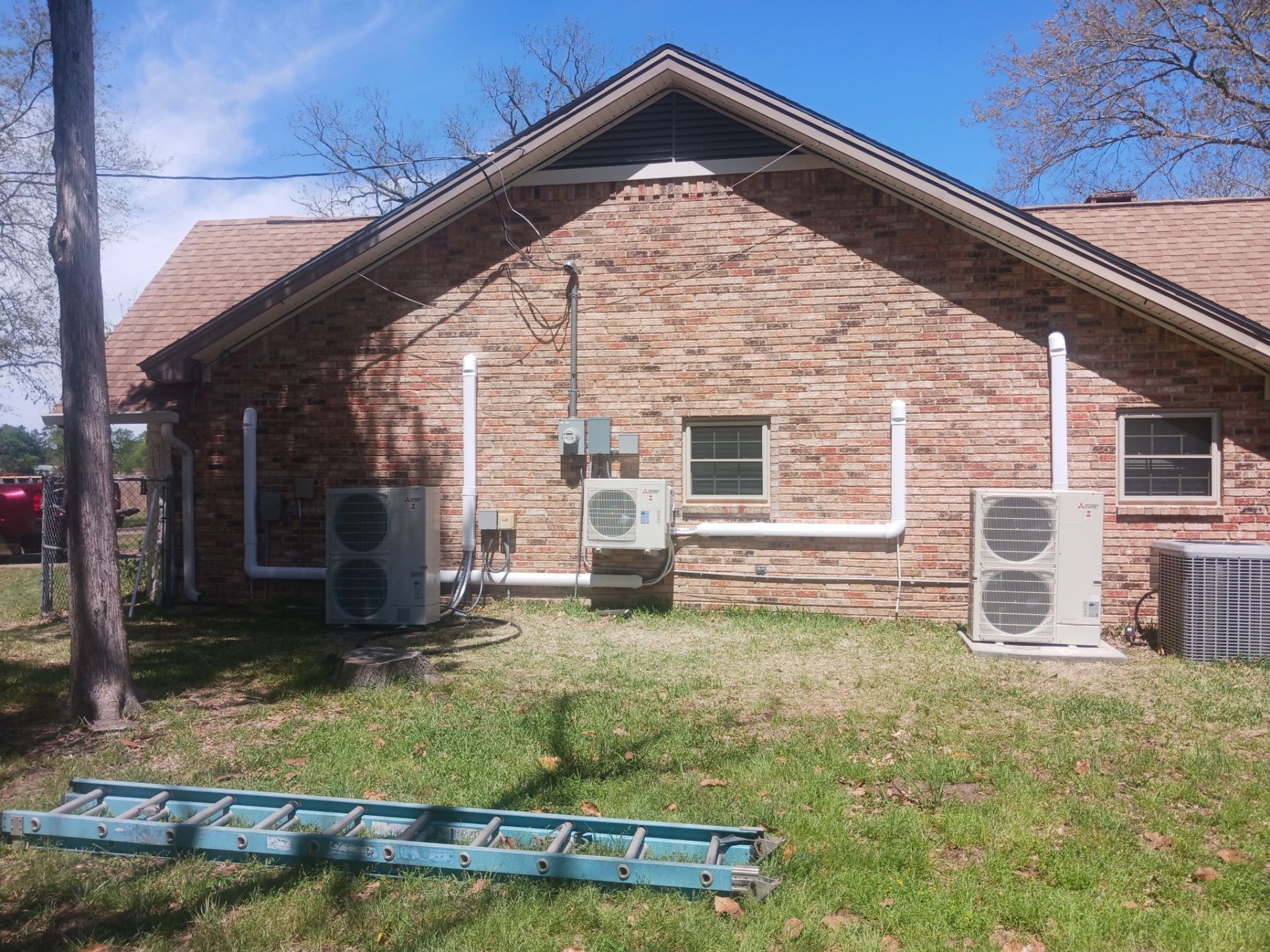 Wall-mounted ductless mini split system installed to cool a hot room on one side of a Houston home